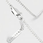 Silver chain necklace with a pendant on a white background