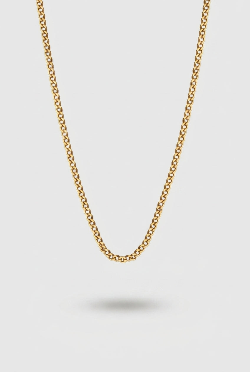Cuban Chain Necklace in Gold on a Light Gray Background