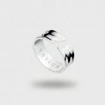 Silver ring with 'VAYLOR' engraving on the inside on a light gray background