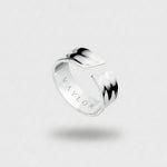 Silver ring with 'VAYLOR' engraving on the inside on a light gray background