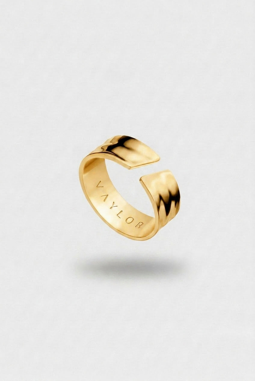 Golden ring on a light gray background