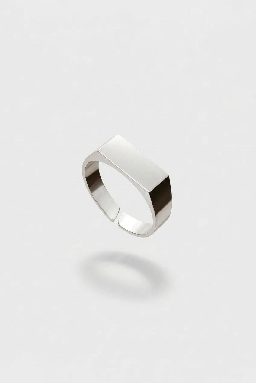Silver ring on a light gray background