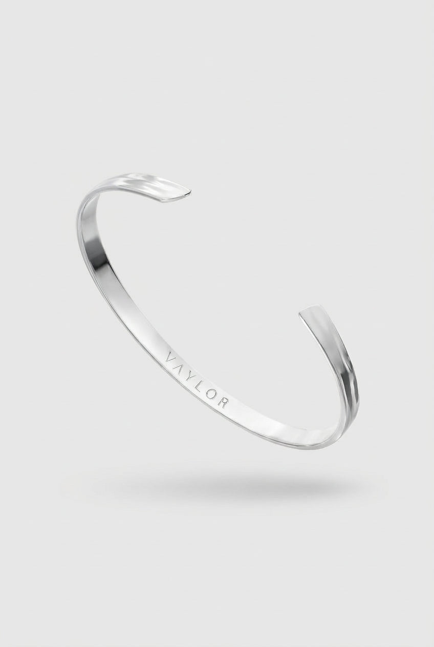 Silver bracelet on a light gray background