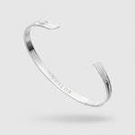 Silver bracelet on a light gray background