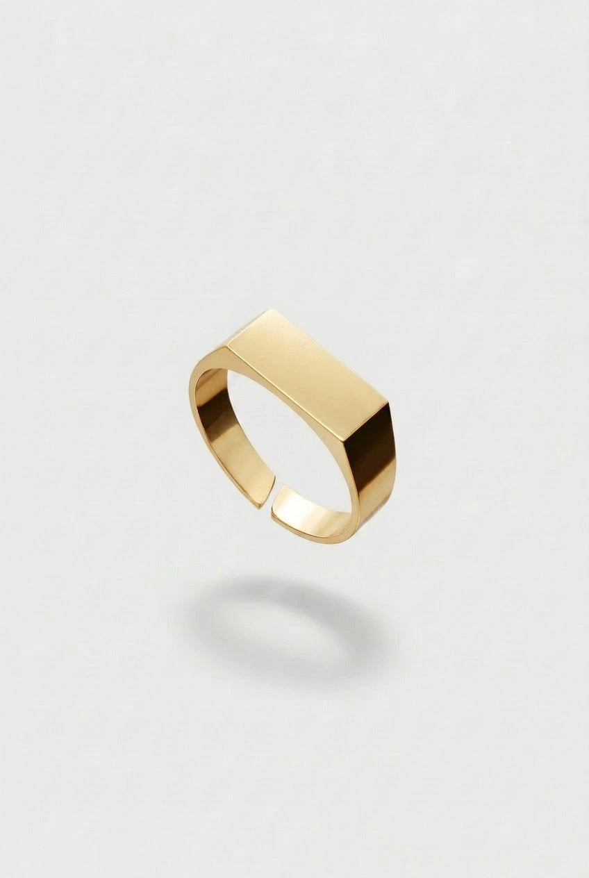 Gold ring on a light gray background