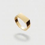 Gold ring on a light gray background