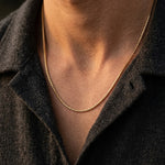Person wearing a golden necklace
