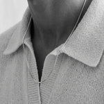 Close up photo of a mens neck with a necklace