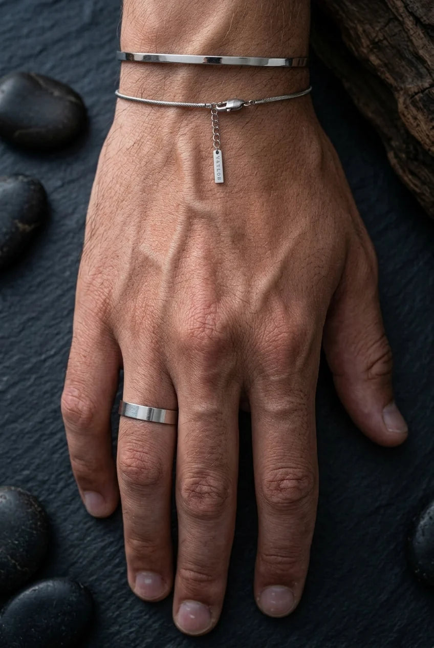 Male hand with a ring, a cuff and a bracelet on it silver