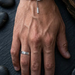 Male hand with a ring, a cuff and a bracelet on it silver