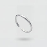 Silver ring on a light gray background