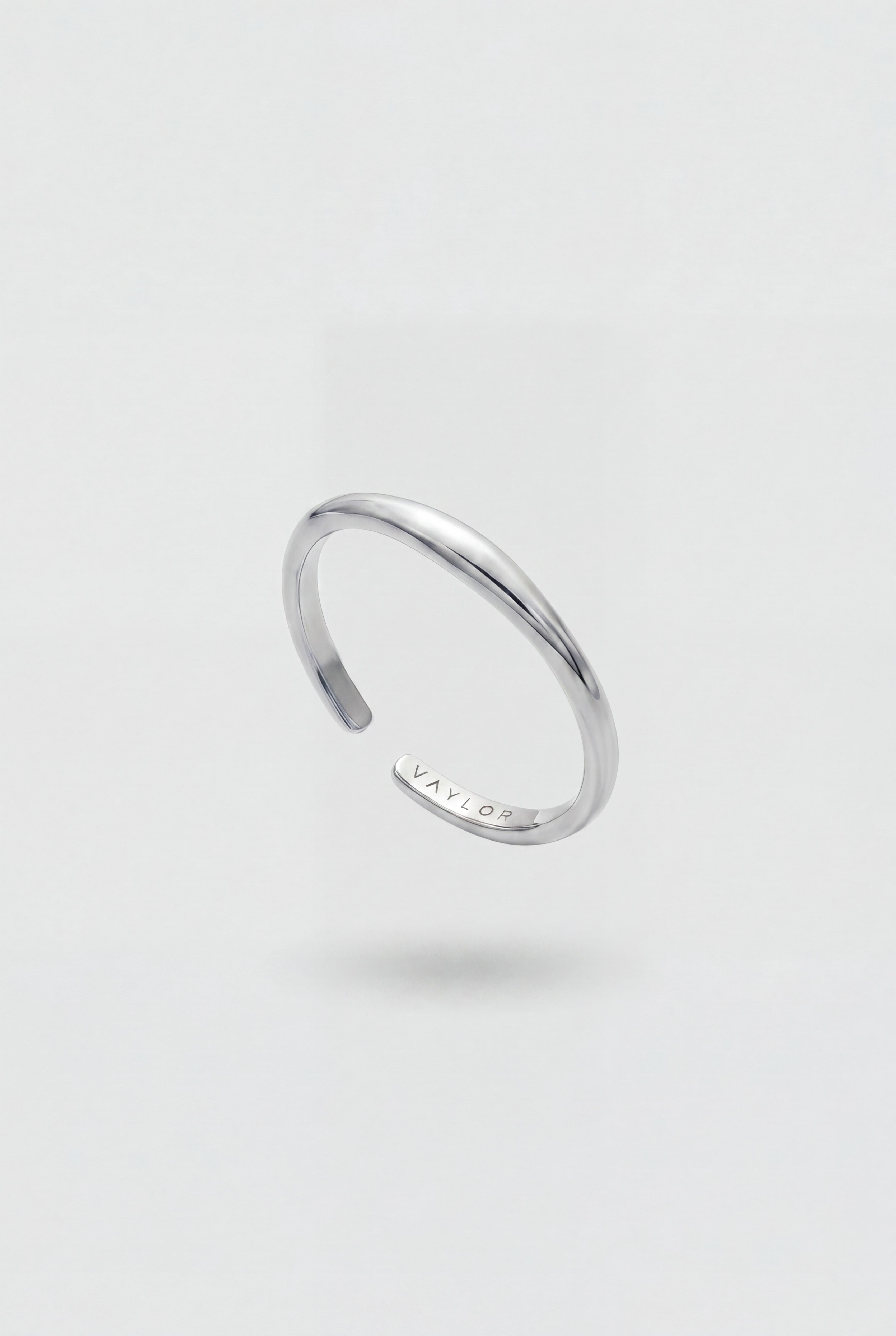 Silver ring on a light gray background
