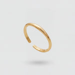 Gold open ring on a light gray background