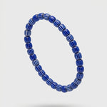 Blue beaded bracelet on a white background