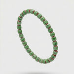 Green beaded bracelet on a white background