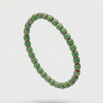 Green beaded bracelet on a white background