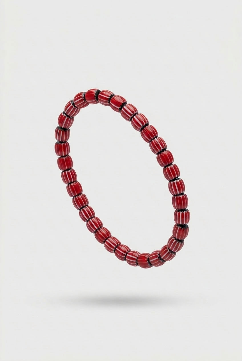 Red beaded bracelet on a white background