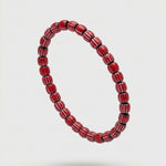 Red beaded bracelet on a white background
