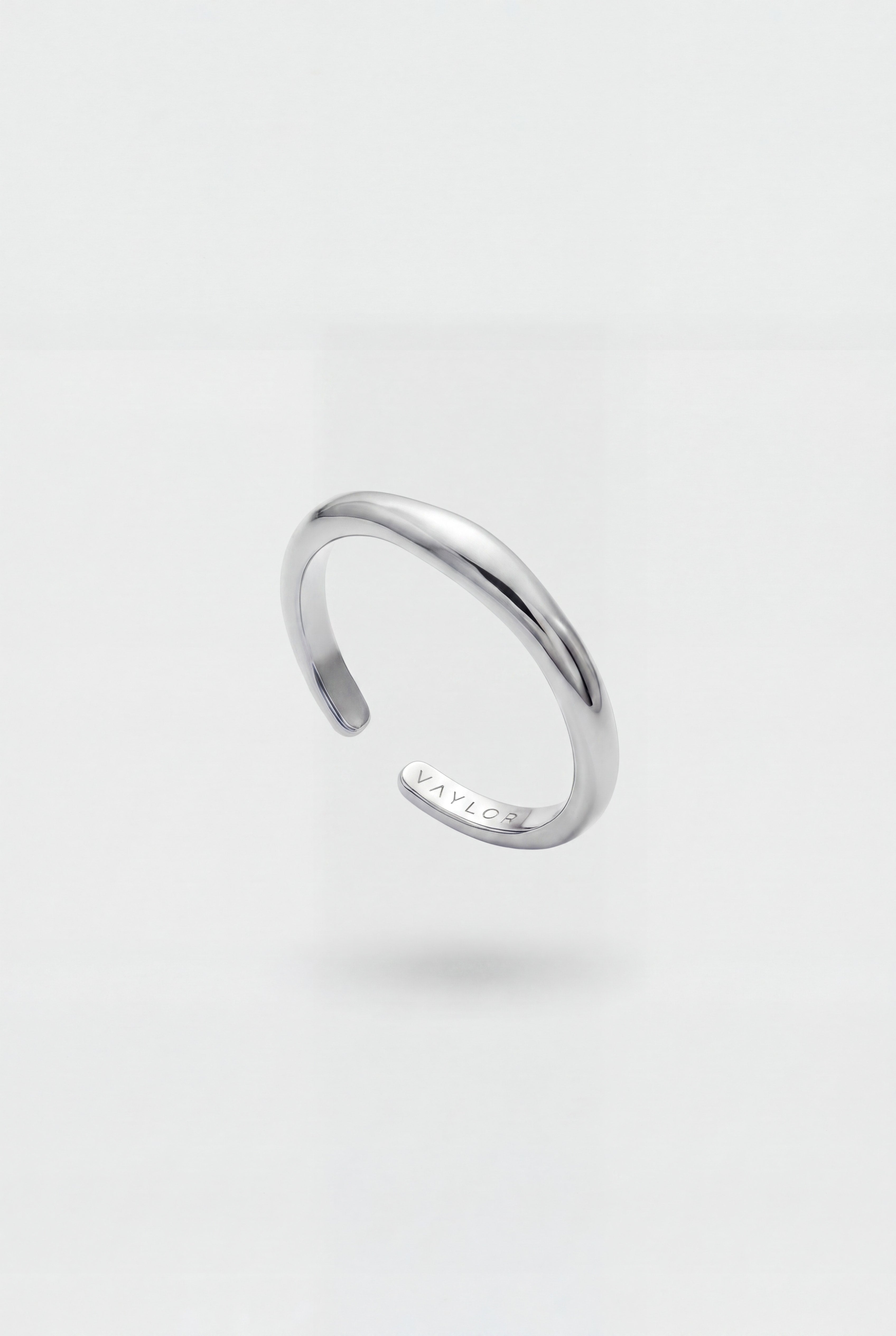 Silver ring on a light gray background