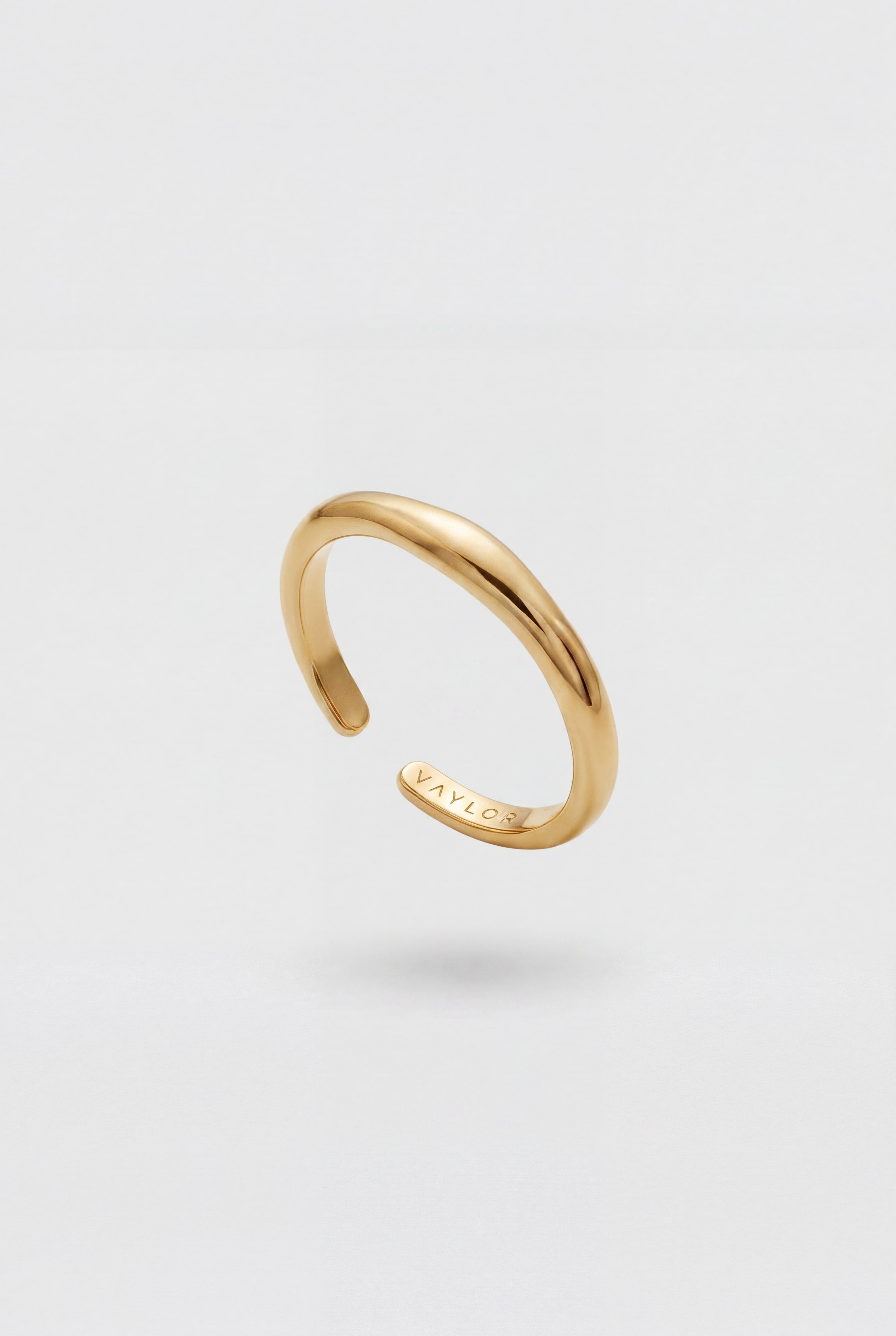 Gold ring on a light gray background