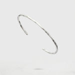 Silver Cuff Bracelet on a light gray background
