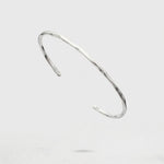 Silver Cuff Bracelet on a light gray background