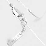 Silver bracelet with a name tag charm on a white background