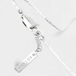 Silver bracelet with a name tag charm on a white background