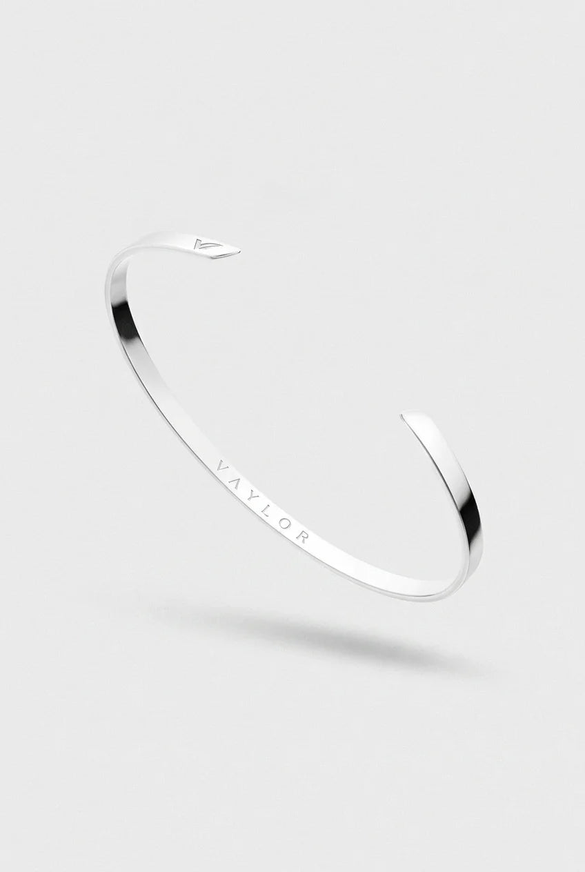 Silver bracelet with 'Vaylor' engraving on a light gray background