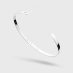 Silver bracelet with 'Vaylor' engraving on a light gray background